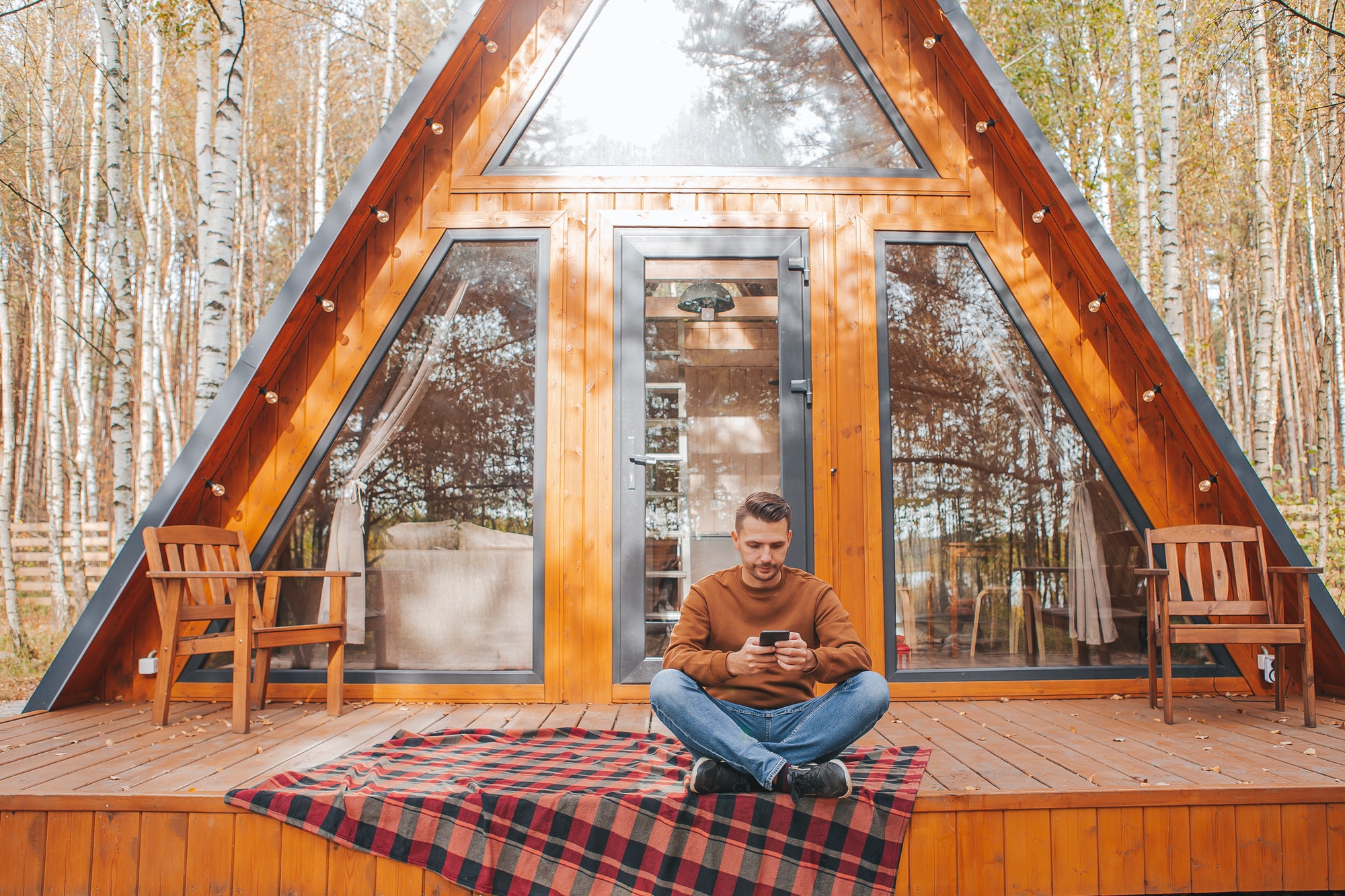 Happy man on the terrace in autumn